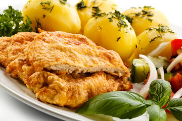 Pork chops, boiled potatoes and vegetable salad