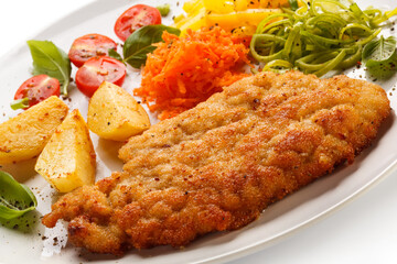 Pork chop, baked potatoes and vegetable salad