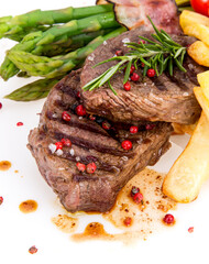 Tasty beef steaks on white background