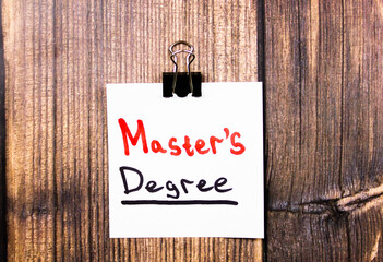 Master's Degree - text concept on a piece of paper on the table.