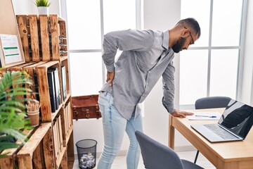 Young hispanic man business worker suffering for backache at office