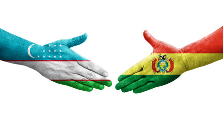 Handshake between Uzbekistan and Bolivia flags painted on hands, isolated transparent image.