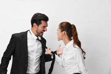 Man and woman anger business hitting on each other screaming with their hands up in the air on a white isolated background. The concept of business in a couple harassment startup copy space