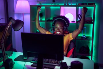 African american woman streamer using computer with winner expression at gaming room © Krakenimages.com