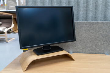 Minimal workspace with computer with blank screen on wooden table in living room