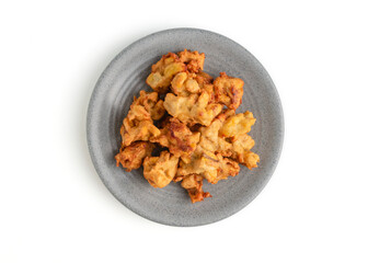 banana fritter or fried banana on a plate and wooden cutting board isolated on white background