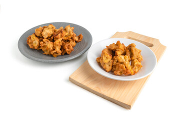 banana fritter or fried banana on a plate and wooden cutting board isolated on white background