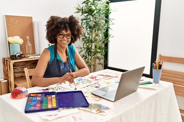 Young african american woman smiling confident having online draw class at art studio