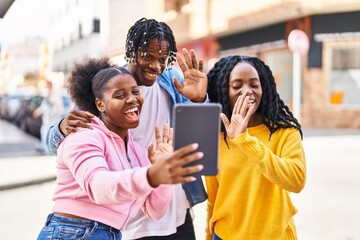 African american friends standing together having video call at street