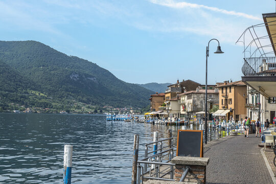 Landscape of the lakeside of Peshiera Maraglio in Monte Isola with beautiful colored houses reflecting in the water