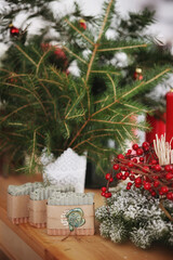 Handmade soap christmas present near christmas tree with decoration on wooden table christmas postcard