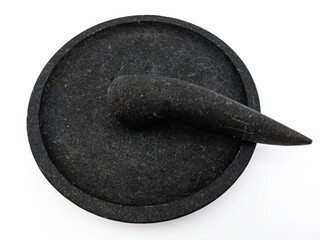 Unique traditional mortar and pestle, stone craft made for mashing seasoning purpose, Cobek and Munthu or Ulekan. Isolated on white background.