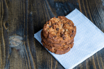 Delicious cookies with pieces of chocolate on the table