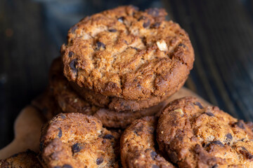 Delicious cookies with pieces of chocolate on the table