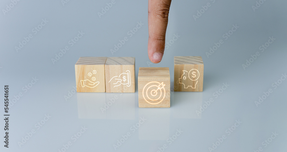 Poster hand pointing at one wood cube block with target icon . concept of business strategy and goal action