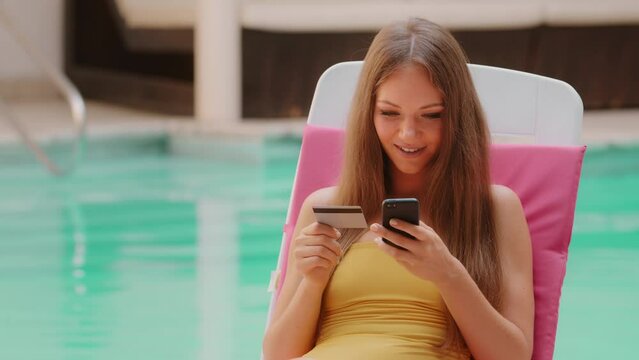 Happy caucasian female shopper buyer woman use smartphone and credit card on summer trip holidays using easy mobile payments shopping online booking travel tickets ecommerce banking service on phone