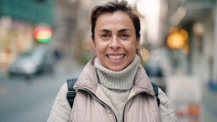 Fototapeta premium Middle age hispanic woman smiling confident standing at street