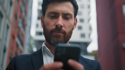 Male portrait businessman freelancer executive worker caucasian 30s man texting messages on mobile phone read media content use city wi-fi 5g internet outside office building modern technology concept - Powered by Adobe