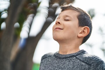 Blond child smiling confident breathing at park - Powered by Adobe