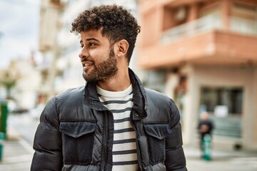 Young arab man smiling outdoor at the town