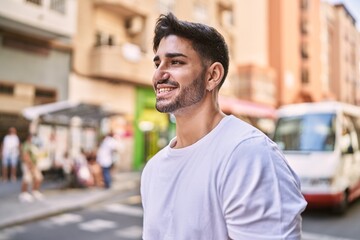 Handsome hispanic man smiling happy outdoors