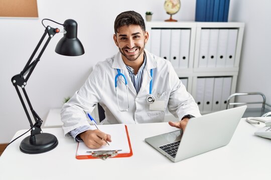 Handsome hispanic man working as doctor at medical consultation