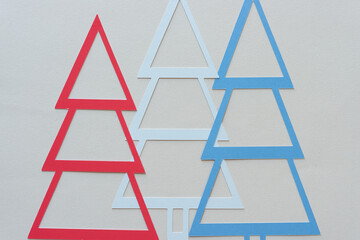 three holiday trees on blank paper