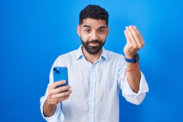 Hispanic man with beard using smartphone typing message doing italian gesture with hand and fingers confident expression