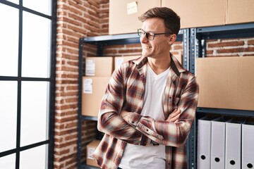 Young man ecommerce business worker standing with arms crossed gesture at office
