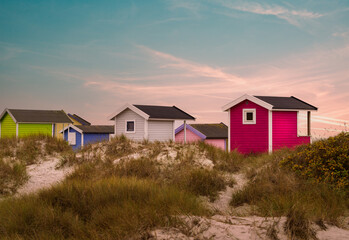 Fototapeta na wymiar Colorful beach huts on beautiful white sand beach in Falsterbo, Sweden. Selective focus.
