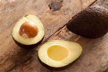Whole and halved ripe avocado pear