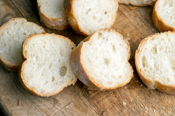 Sliced wheat baguette on a board