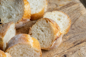 Sliced wheat baguette on a board