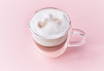  One cup of cappuccino coffee over pink background