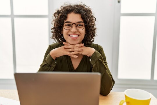 Young hispanic woman smiling confident working at office