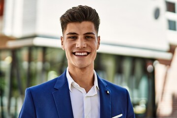 Young man smiling confident wearing suit at street