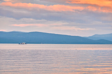 Kurbulik, Republic of Buryatia, Russia - July 11, 2022: A ship with tourists in the Chivyrkuysky Bay of Lake Baikal.
