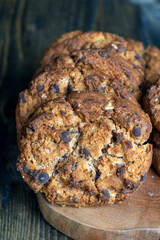 Delicious cookies with pieces of chocolate on the table