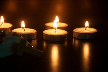 Candle lights and dark black background with customizable space for text or ideas. Copy space and Christian religion concept.