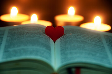 Red heart shape on Holy Bible with customizable space for text or ideas. Copy space and religion...