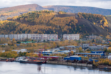 Industrial pier on the bank of the river with a loading crane.