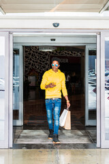 Young man leaving a shopping mall