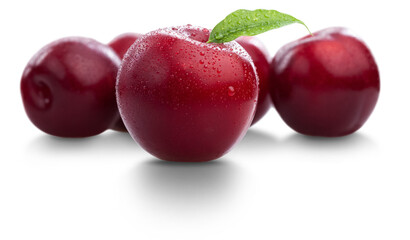 Red cherries and plum fruit isolated on white background