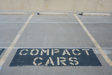 Parking spot with sign it is for compact car parking only
