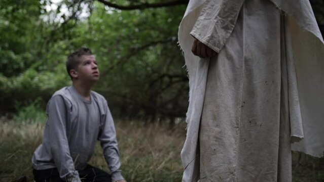 Jesus Christ helps a sad teen boy