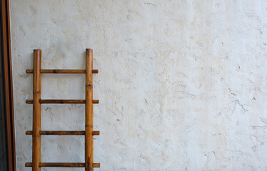 Bamboo racking and white concrete wall with copy space.