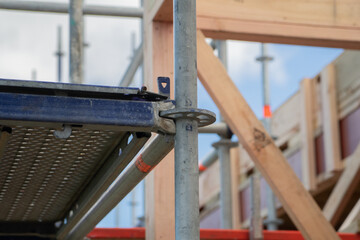 Metal scaffolding and wood building construction, building site