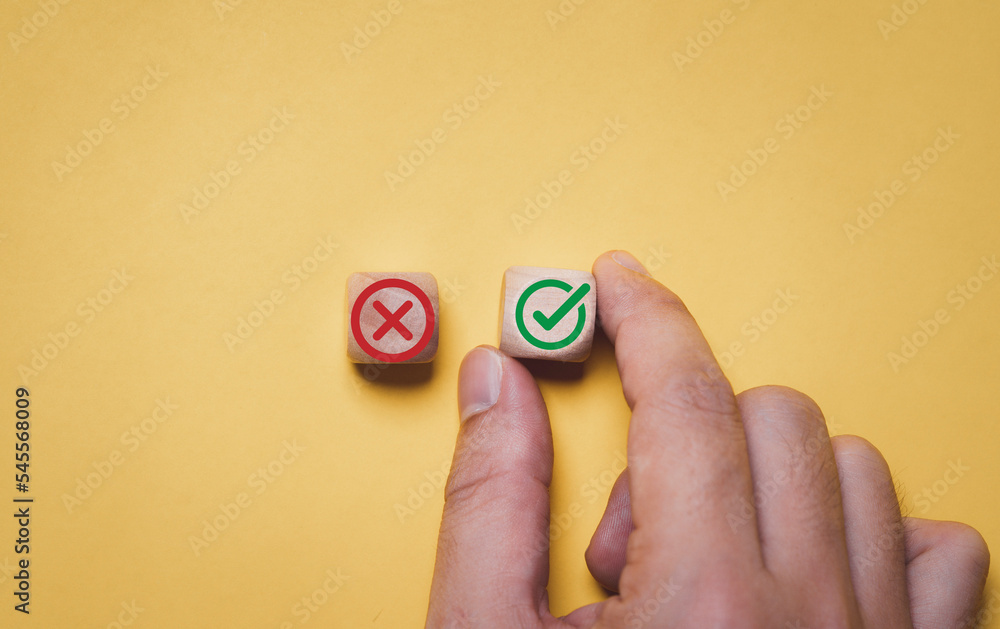 Aufkleber Businessman select green correct sign mark between Red Cross mark which print screen on wooden cube block for approve and reject business proposal concept.