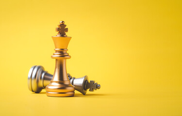 Stand of golden king chess and fallen silver king chess. Winner of business competition and marketing strategy planing concept.