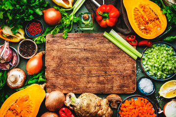Autumn food. Vegetables, mushrooms, roots, spices, wood cutting board - ingredients for vegan,...